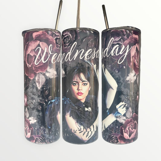 Wednesday Tumbler featuring the charachter in the middle, the name above with pink flowers and a black background