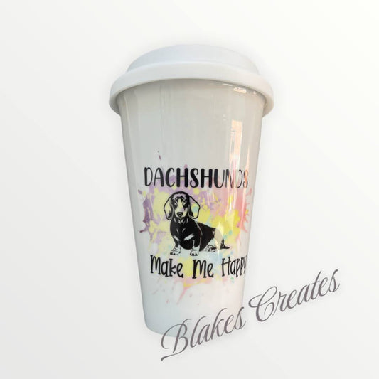 Dachshund on a ceramic travel mug with dachshunds make me happy written on it with a colour splash design by blakes creates